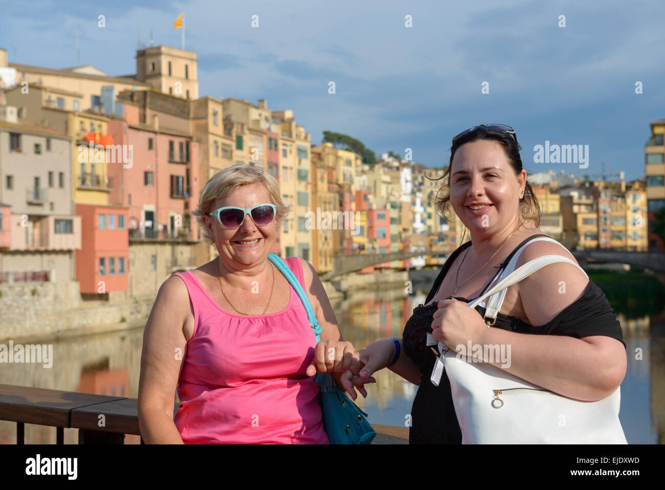 Due donne turisti, madre e figlia sullo sfondo di famose case colorate in Girona, Spagna. Foto Stock