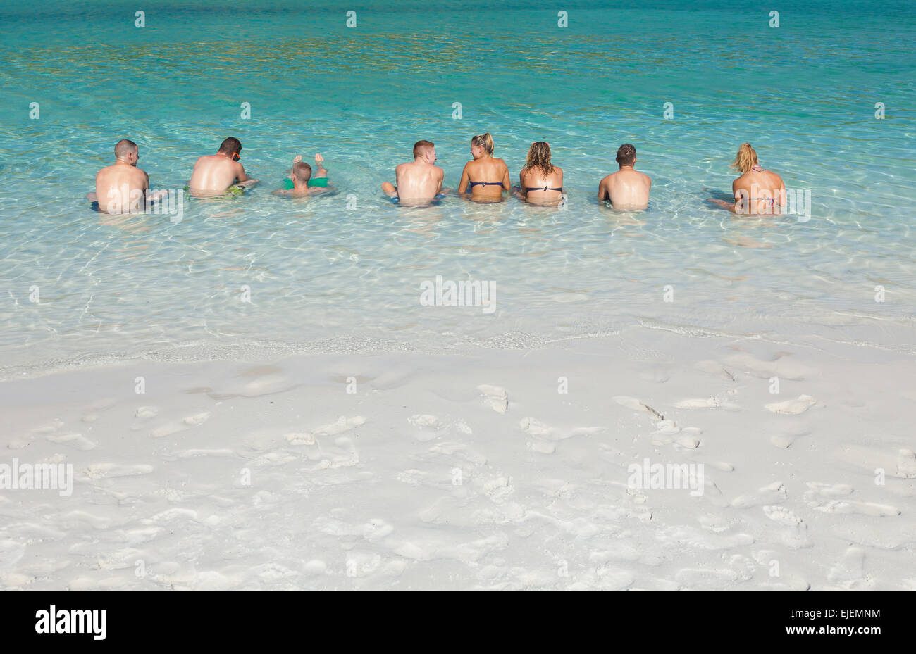 Un gruppo di giovani uomini e donne relax al mare Foto Stock
