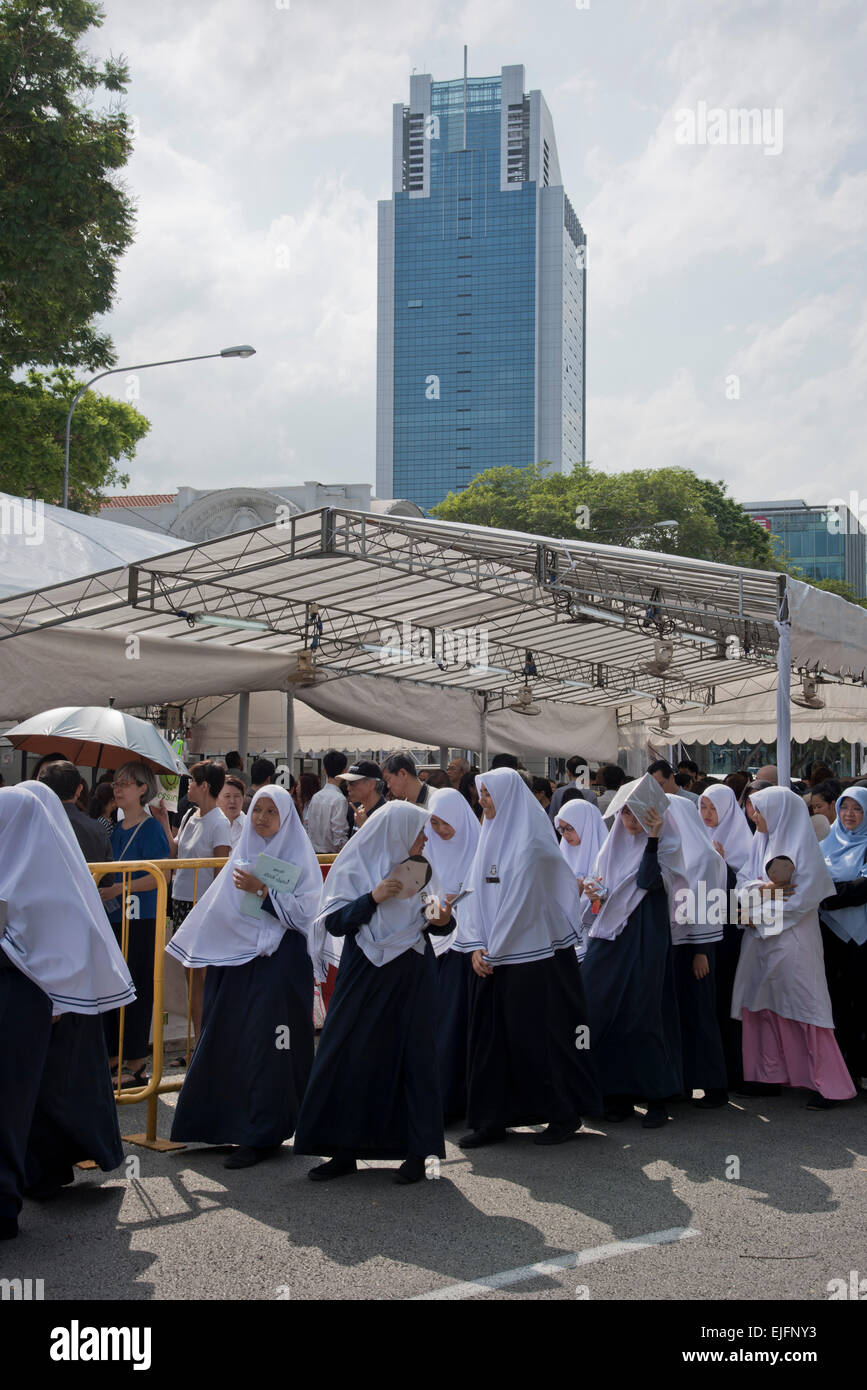 Un enorme coda formata in central Singapore come migliaia di attendere per rendere omaggio al più tardi Lee Kuan Yew giacenti nello stato in parlamento. Le donne musulmane in linea. Foto Stock