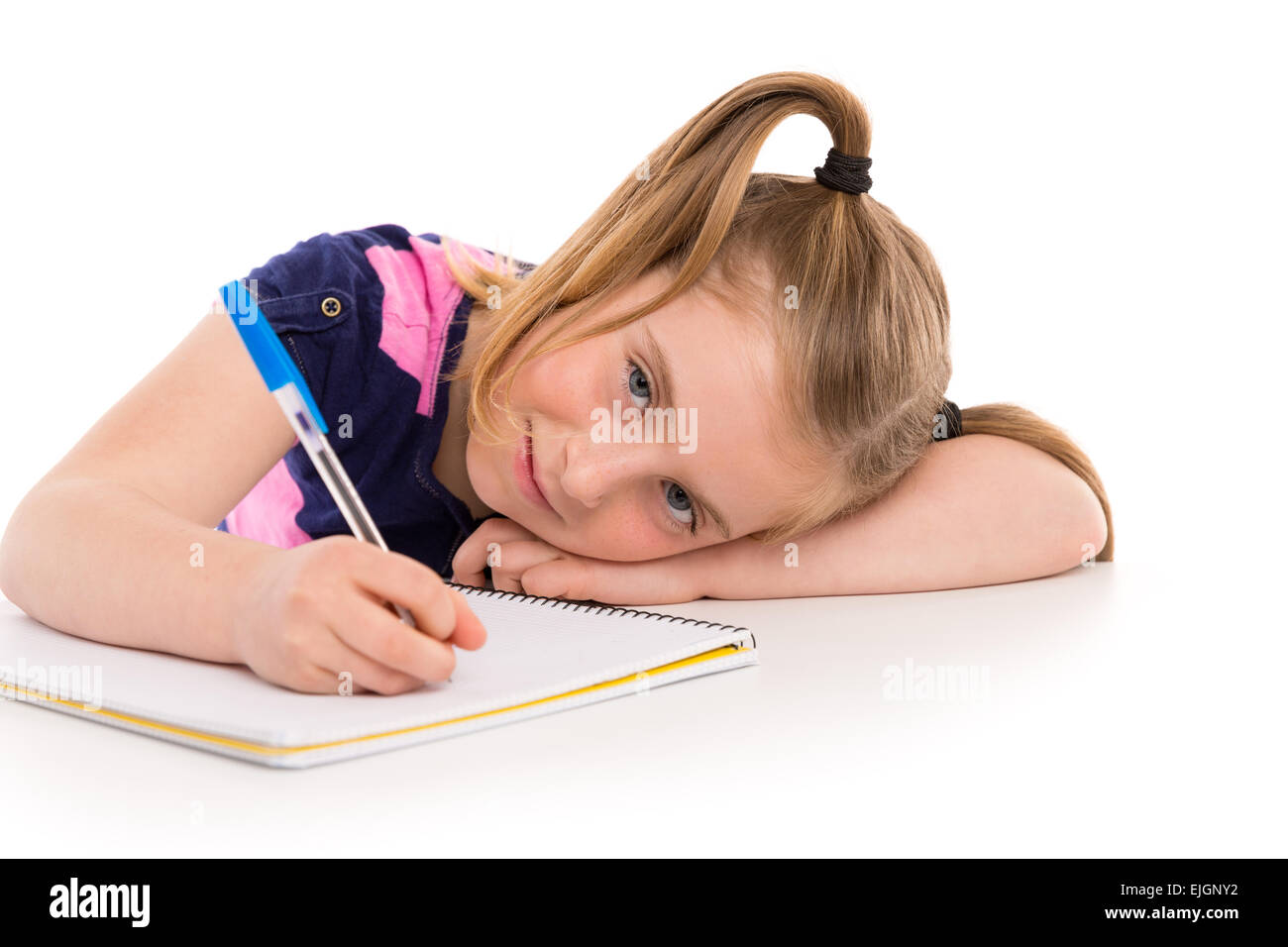 Blonde kid frastagliata una studentessa con notebook a spirale nel banco della pupilla Foto Stock