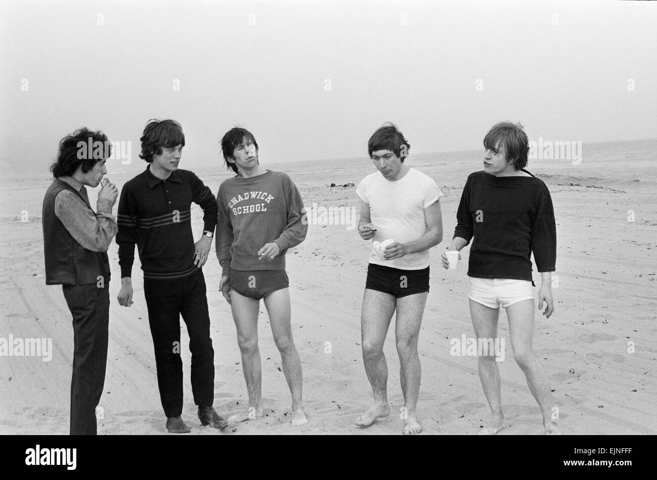 Il Rolling Stones. Bill Wyman, Mick Jagger, Keith Richards, Charlie Watts e Brian Jones visto qui in posa su Malibu Beach. Secondo i fotografi ' i ragazzi avevano alcuni hamburger e calcio giocato e sono stati felici di essere accanto al mare' tuttavia era troppo freddo per nuotare. Durante la banda del primo tour USA, 4 giugno 1964 Foto Stock