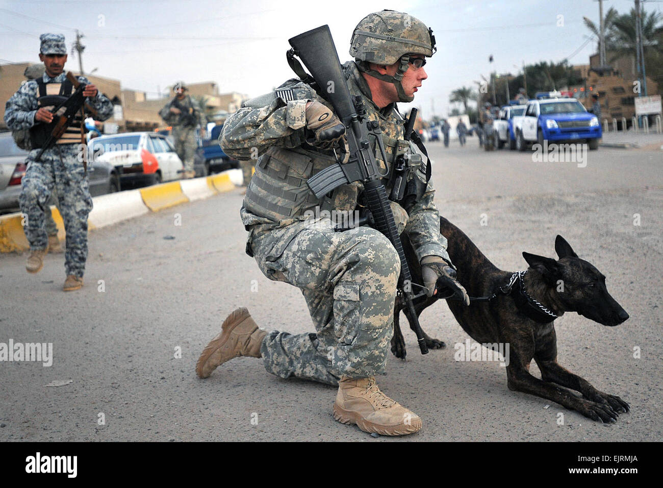 081129-N-1810F-389. Inoltra una base operativa FALCON, Iraq - Staff Sgt. Christopher Ogle, nativo di Beaver Creek, Ohio, e la polizia militare dog handler, conduce il suo cane assegnato, "Liaka", un pastore Olandese, lungo strade in Hadar comunità durante una missione con la società C, 2° Battaglione, 4° Reggimento di Fanteria, fissata per il 1° Brigata Team di combattimento, 4a divisione di fanteria, Divisione multinazionale - Bagdad, iracheni e forze di polizia nazionali su un combinato di pattuglia di sicurezza nov. 29, a sud di Baghdad Rashid distretto. Petty Officer 2a classe Todd Frantom, fissata per il 1° BCT PAO, quarta Inf. Foto Stock