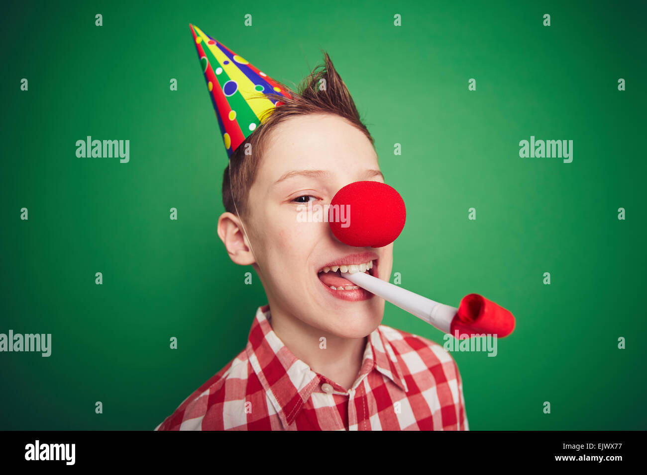 Funny kid con naso rosso divertirsi sulla festa di compleanno Foto Stock