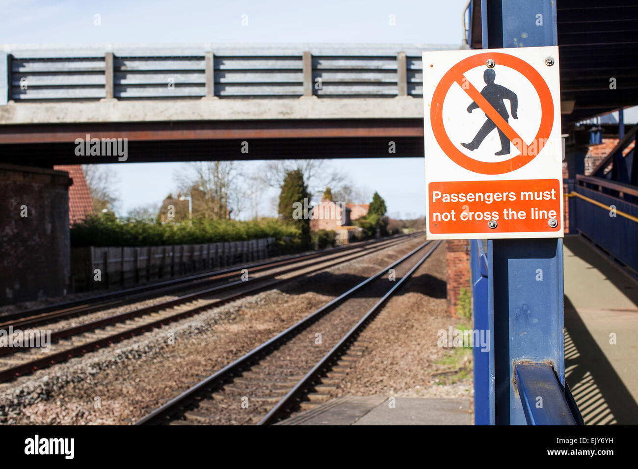 Regno Unito stazione ferroviaria segno che indica che "i passeggeri non devono attraversare la linea' Foto Stock