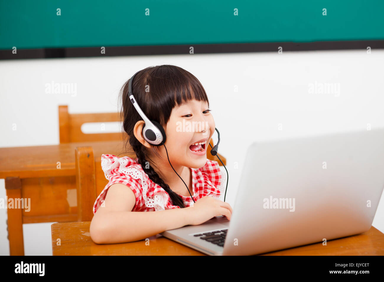 Felice bambina computer di apprendimento in aula Foto Stock