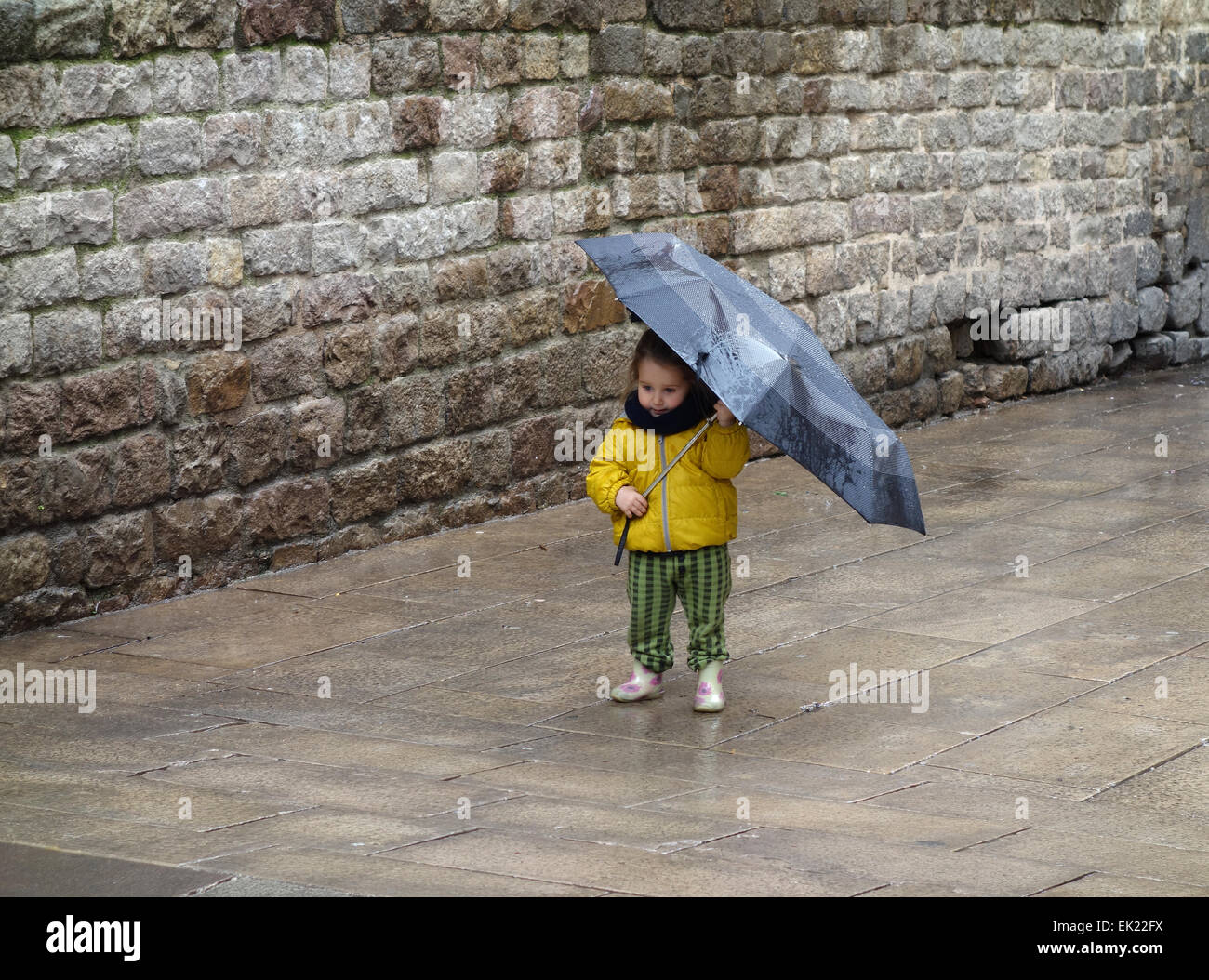 Ragazza giovane con ombrello sul giorno di pioggia dalla chiesa in Plaça de Sant Josep Oriol, Quartiere Gotico di Barcellona Foto Stock