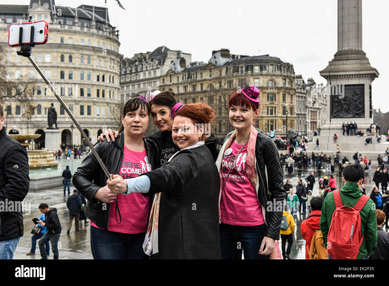Le donne da un partito di gallina tenendo un selfie in Trafalgar Square a Londra. Foto Stock