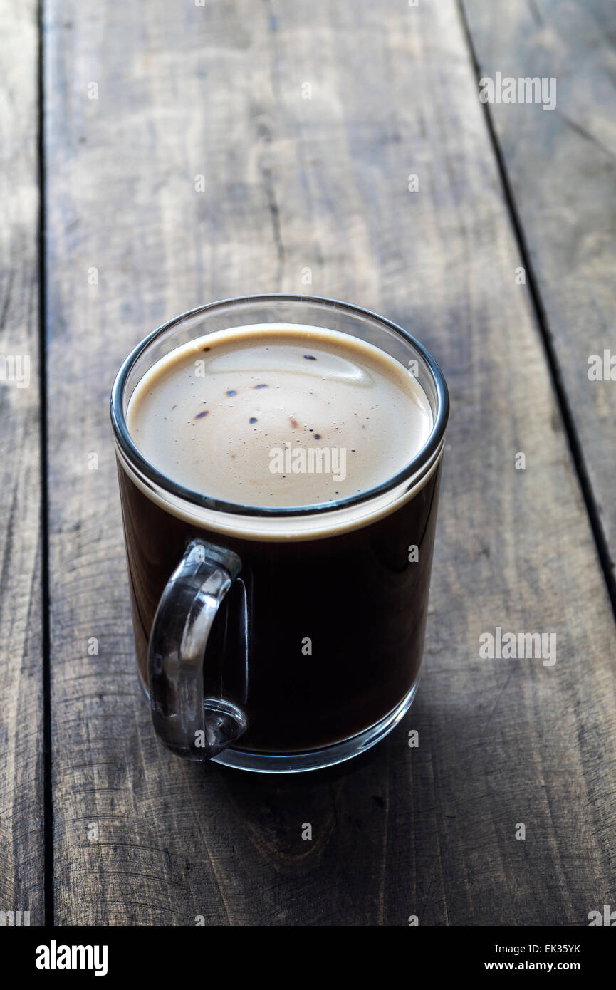 Tazza di caffè su sfondo di legno, retroilluminato Foto Stock