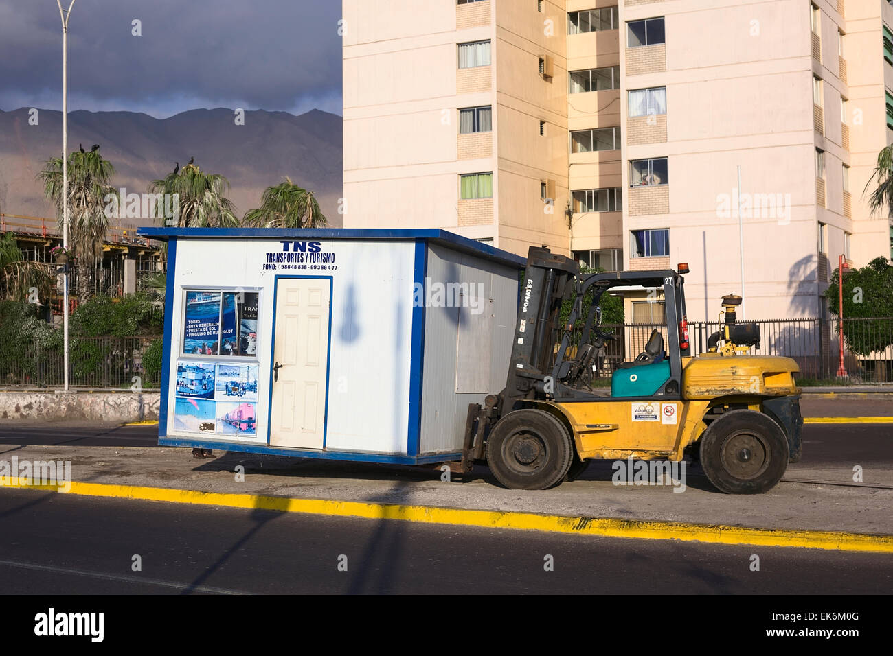 IQUIQUE, Cile - 22 gennaio 2015: piccolo stand che viene sollevato con un carrello elevatore a forche su Arturo Prat Chacon avenue Foto Stock