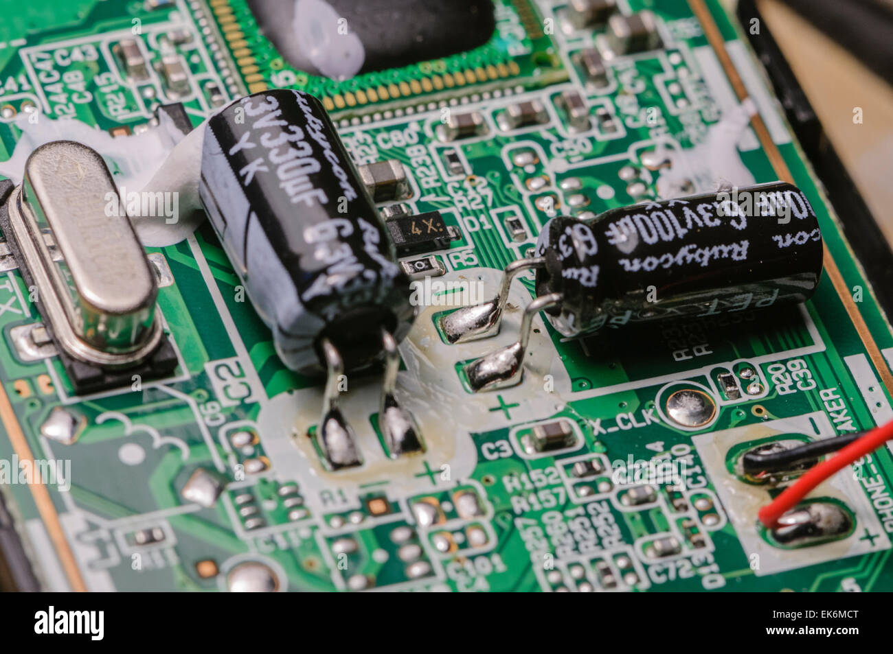 Condensatori, resistori e un cristallo su una scheda a circuito stampato Foto Stock