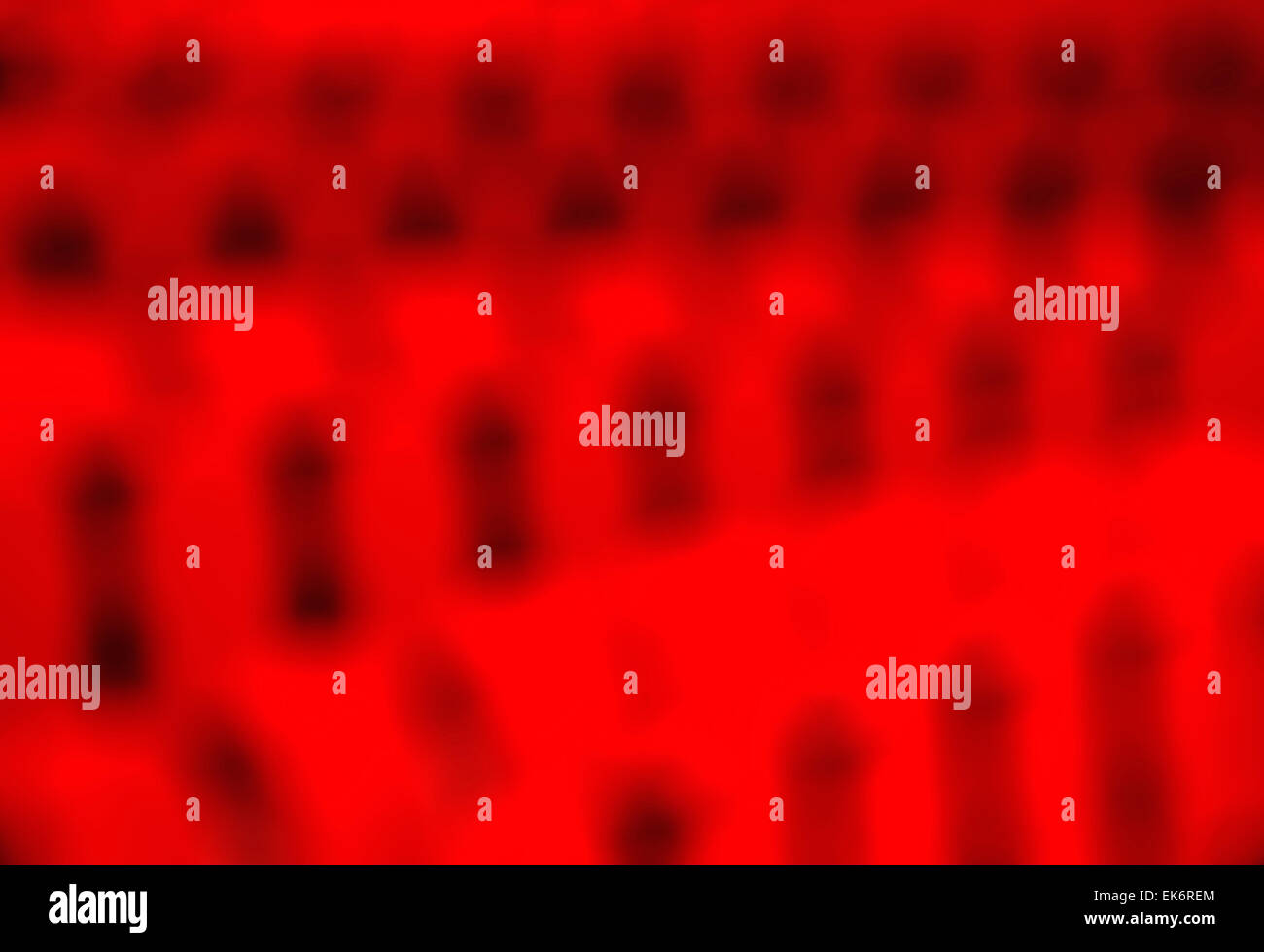 Abstract sfocato, fuori fuoco vista delle righe di colore rosso brillante sedie in un auditorium Foto Stock