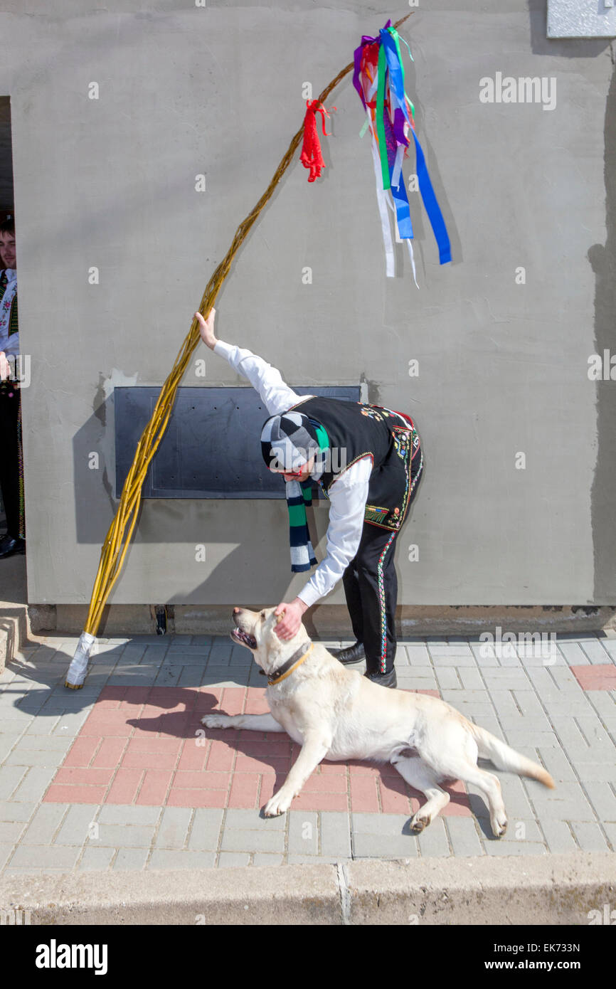 Lunedì di Pasqua - un giovane uomo e un cane con una frusta in costume popolare durante la tradizionale festa delle ragazze frustate, cane della Repubblica Ceca frusta pasquale Foto Stock