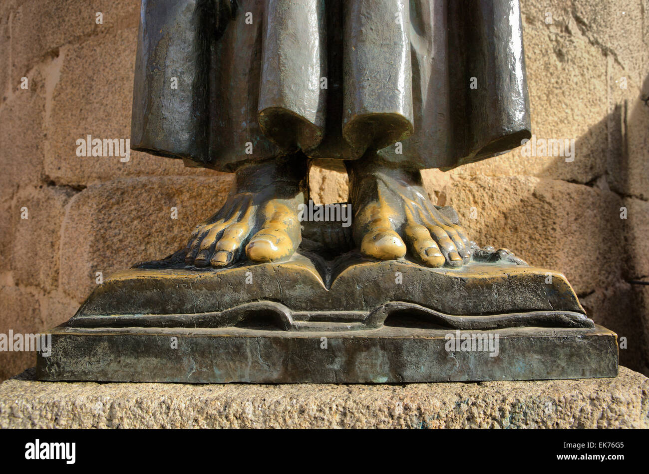Bronzetto statua piedi sul libro dal monaco San Pedro de Alcantara, Caceres, Spagna Foto Stock