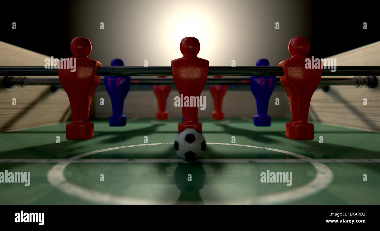 Una metà di un biliardino tabella a livello del suolo con un pallone da calcio di fronte al team rosso pronto per il kick off di una partita di calcio Foto Stock