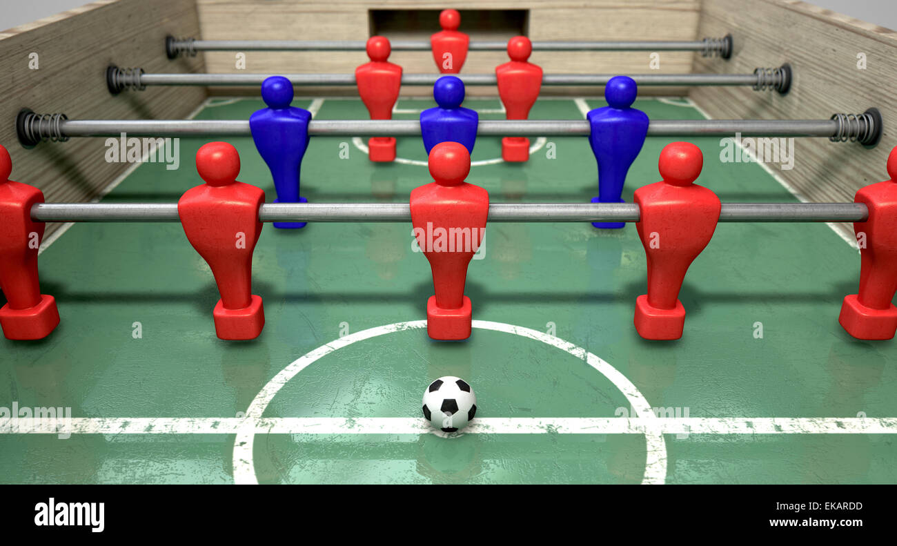 Una metà di un biliardino tabella a livello del suolo con un pallone da calcio di fronte al team rosso pronto per il kick off di una partita di calcio Foto Stock