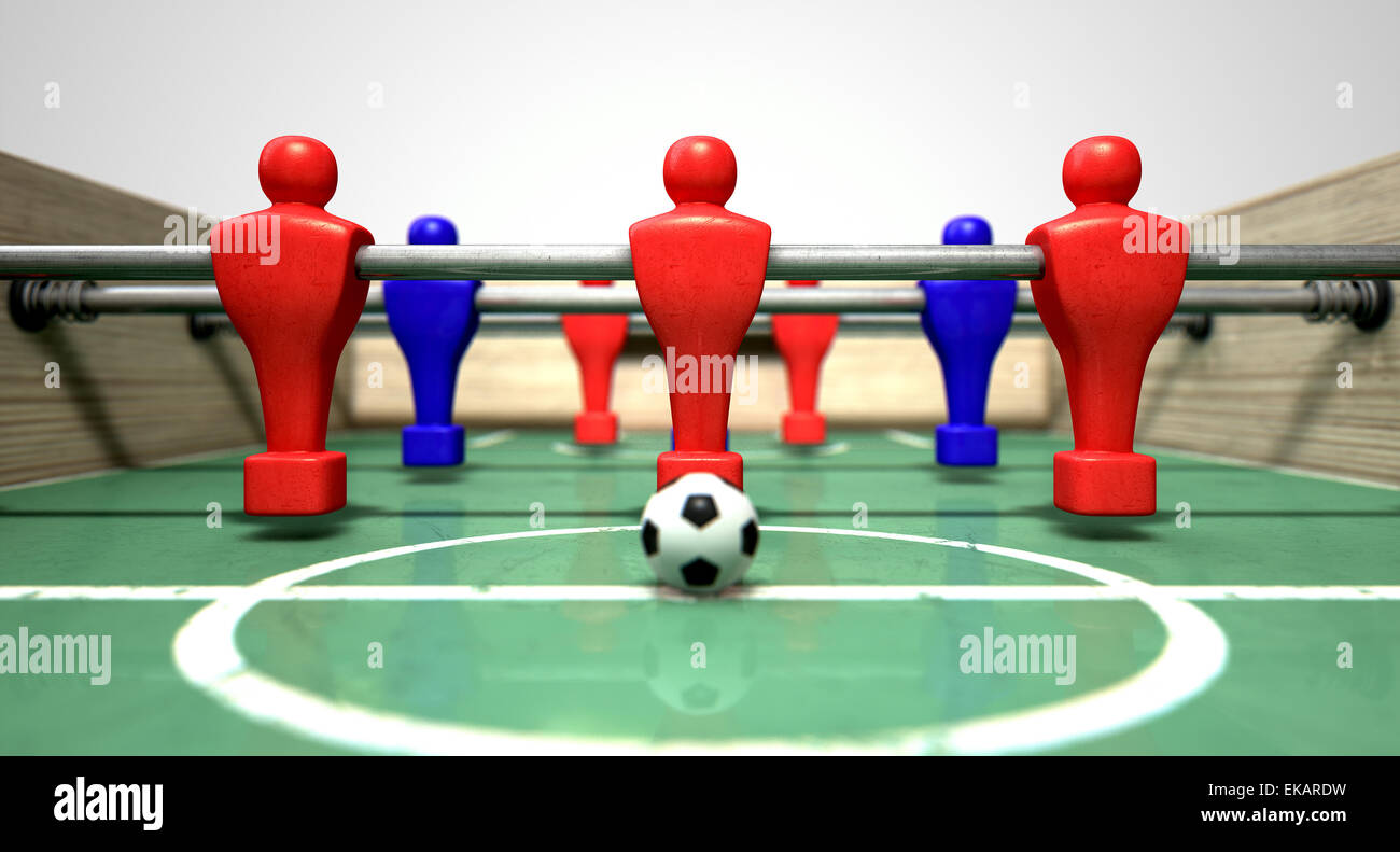 Una metà di un biliardino tabella a livello del suolo con un pallone da calcio di fronte al team rosso pronto per il kick off di una partita di calcio Foto Stock