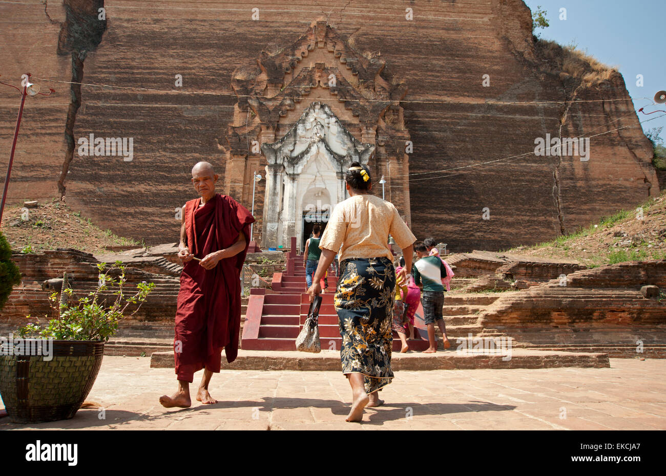 Un monaco birmano si allontana dalla parte anteriore del terremoto danneggiato enorme pagoda di mattoni a Mingun vicino a Mandalay MYANMAR Birmania Foto Stock