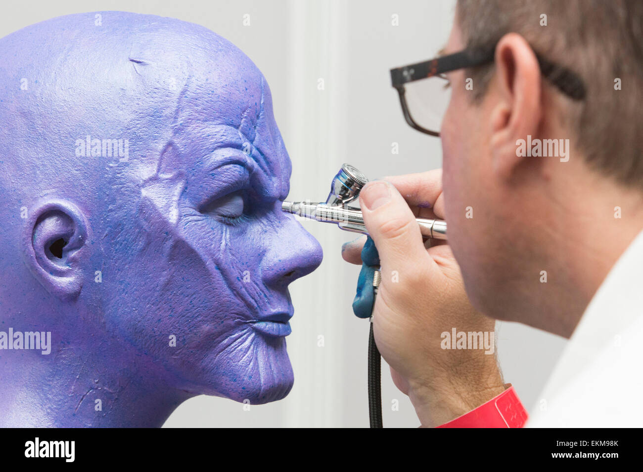 Londra, Regno Unito. 12 aprile 2015. Trucco artisti Ciad Washam da Make-up designory aerografi trucco per una versione femminile dei vendicatori' villain Thanos. Regno Truccatori Expo (UMAe), il Regno Unito che conduce agli aspiranti e professionali per capelli e trucco artisti trade show, ottiene in corso presso il Business Design Centre di Islington, London, Regno Unito. Si corre fino a domenica 12 aprile. A questo trade show professionisti leader di fornire dimostrazioni e le tecniche più recenti e i prodotti sono presentati. Credito: bas/Alamy Live News Foto Stock