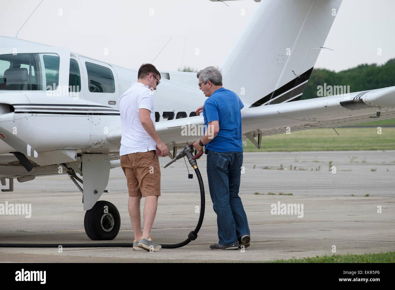I piloti si preparano a fare rifornimento piccolo due twin motore aereo con benzina avio il tubo flessibile ed un ugello Foto Stock