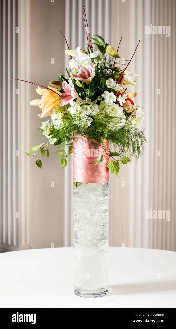 Un vaso di fiori su un tavolo per un matrimonio. Foto Stock