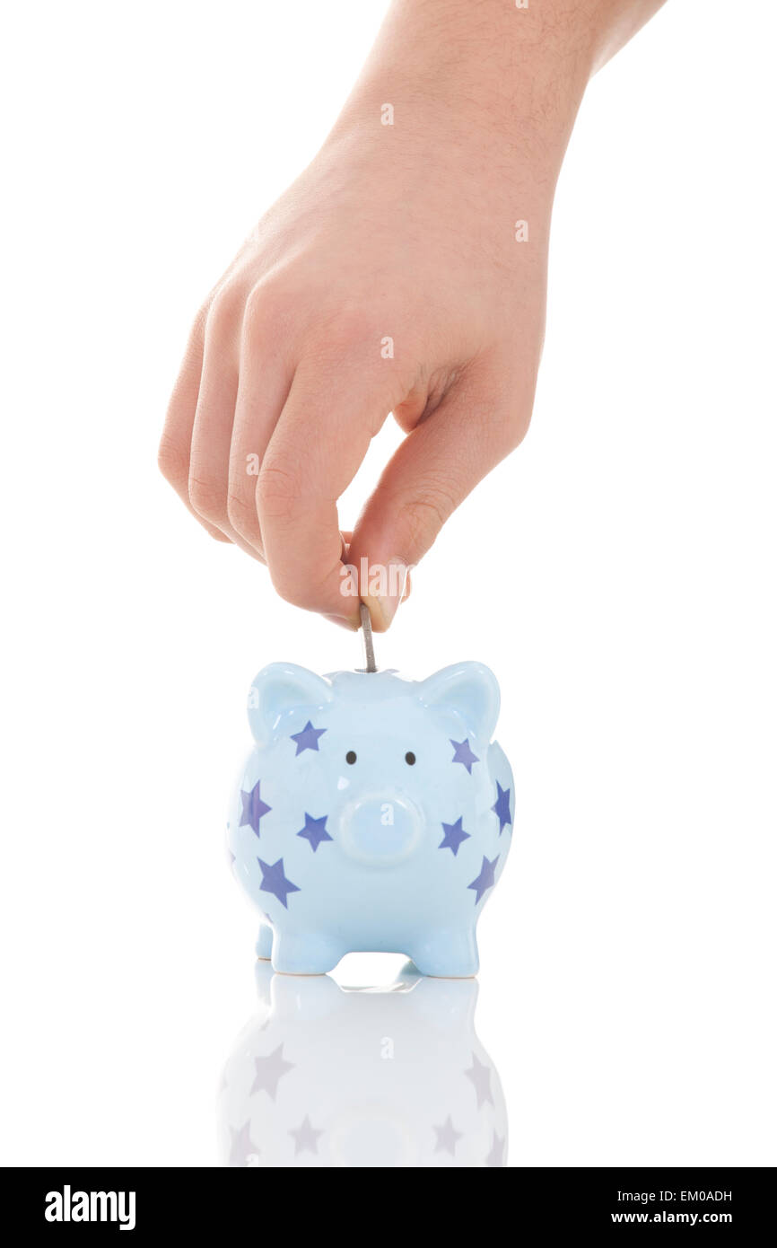Risparmio - salvadanaio e la mano con moneta Foto Stock