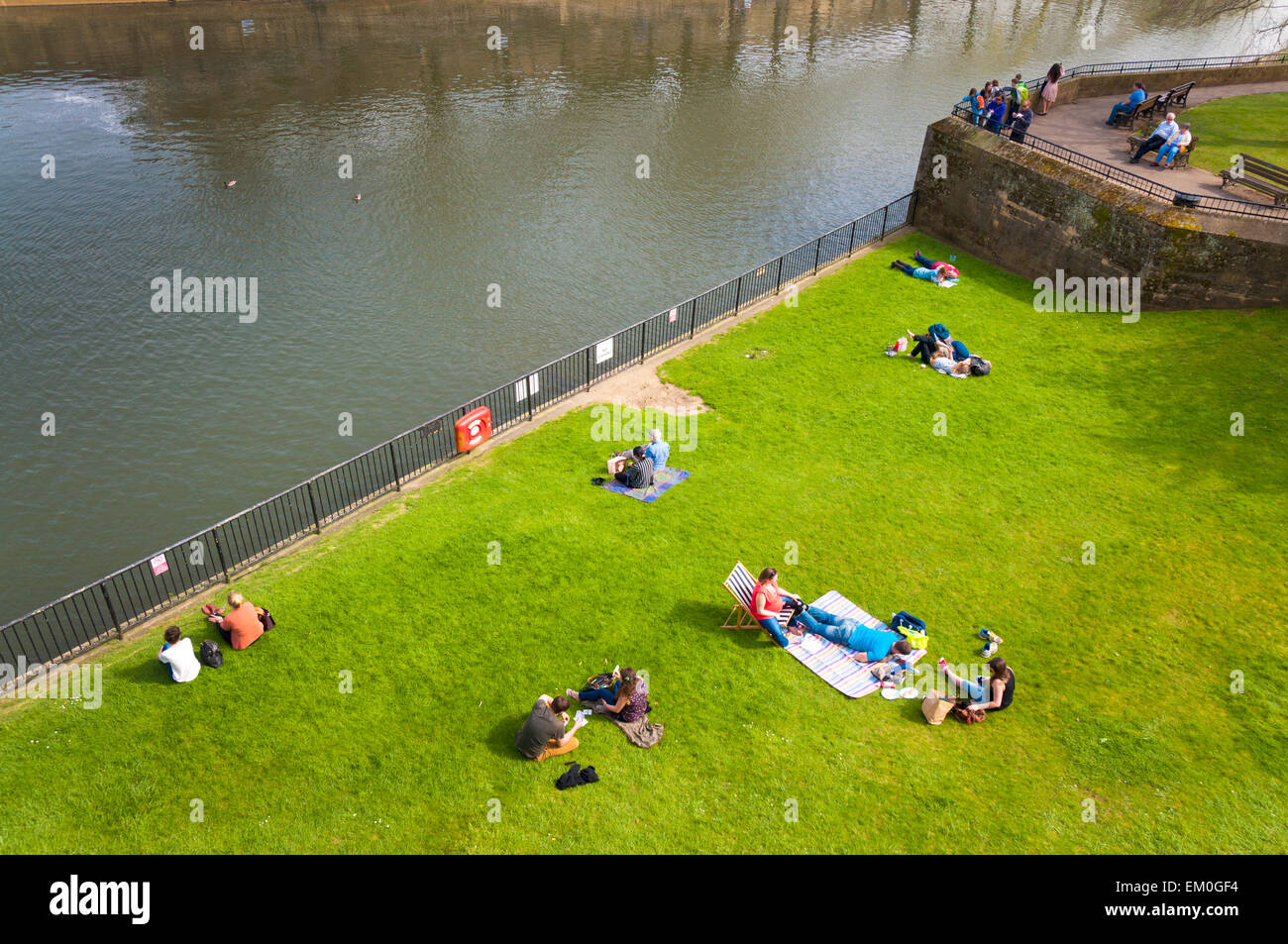 Le persone a rilassarsi nella Parade Gardens lungo il fiume Avon a Bath Somerset England Regno Unito Foto Stock