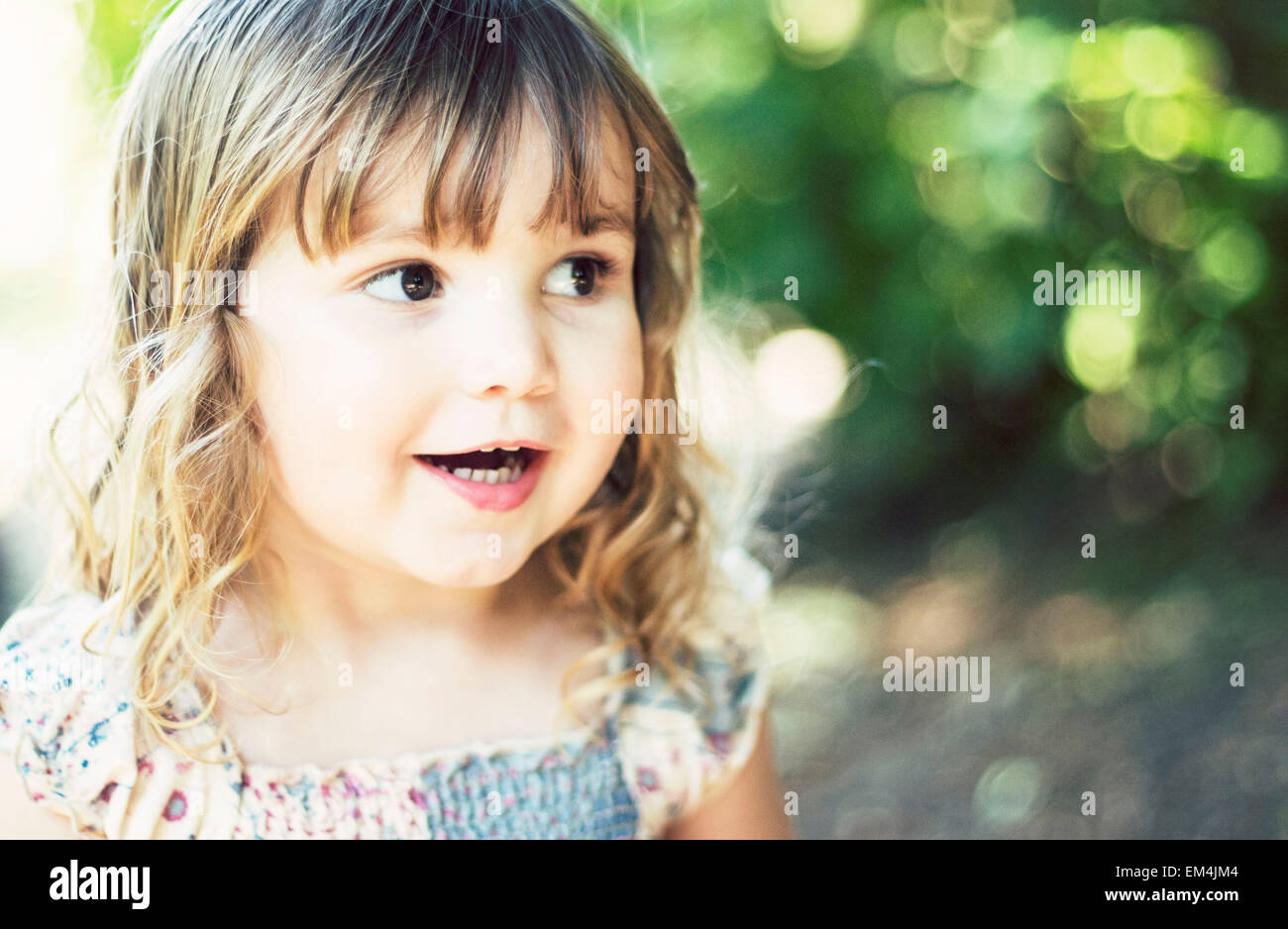 Ragazza, figlia, luce verde, marrone capelli, sorridendo felice bokeh di fondo Foto Stock