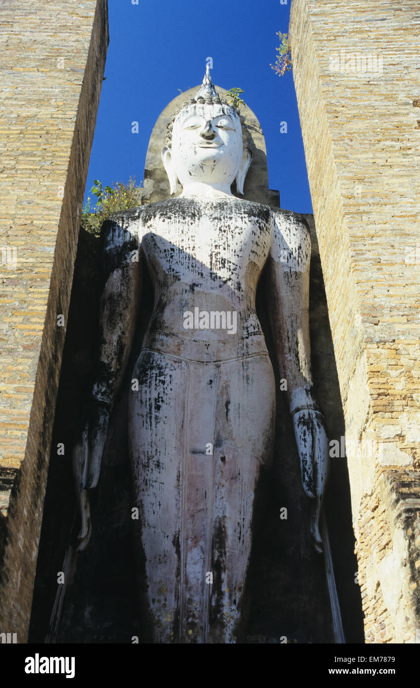 Thailandia, Sukhotha, basso angolo di visualizzazione permanente della statua di pietra tra pilastri; Wat Mahathat Foto Stock