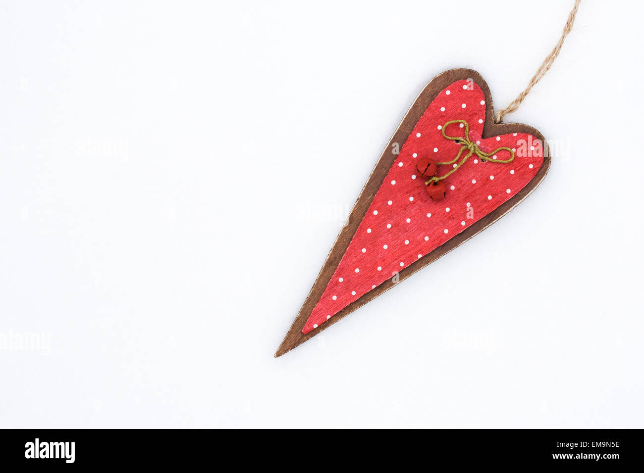Un rosso di legno decorativo cuore su uno sfondo bianco. Foto Stock