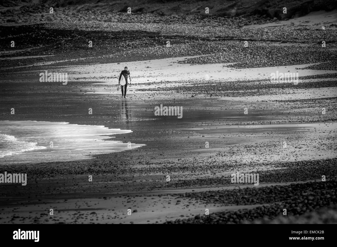 Lone surfer sulla spiaggia di Traigh Siar, Vatersay, Isle of Barra, Ebridi Esterne, REGNO UNITO Foto Stock