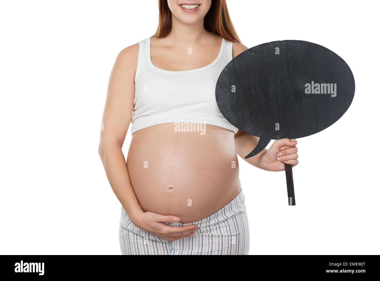 Donna incinta tenendo il dialogo nube nei pressi del suo ventre Foto Stock