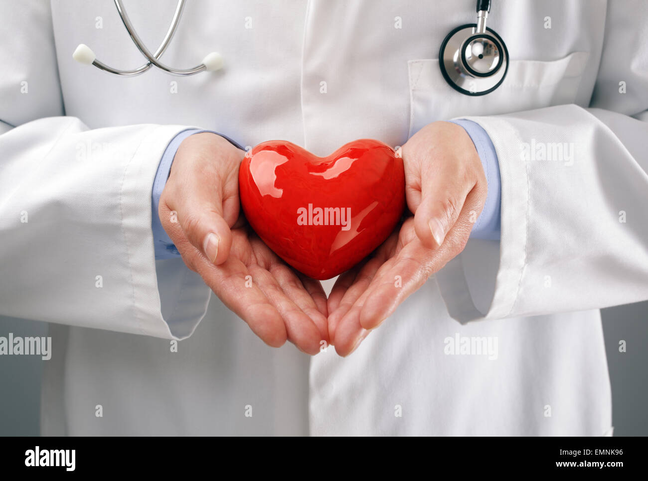 Medico tenendo cuore con cura Foto Stock