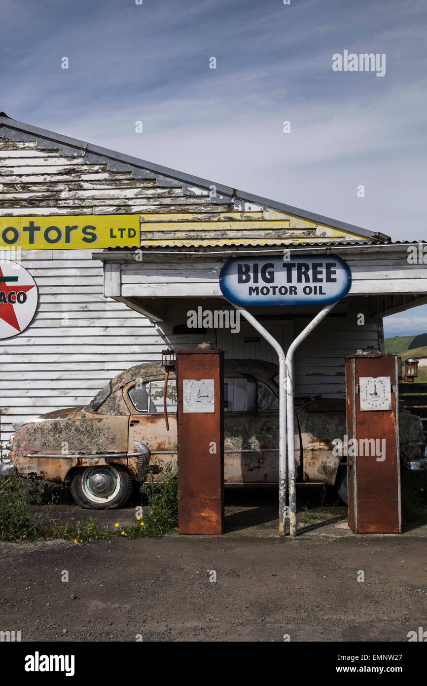 Vecchia abbandonata la stazione di benzina con una Plymouth Belvedere degli anni cinquanta auto e due pompe di benzina, di marciume sul piazzale. Ormondville, Foto Stock