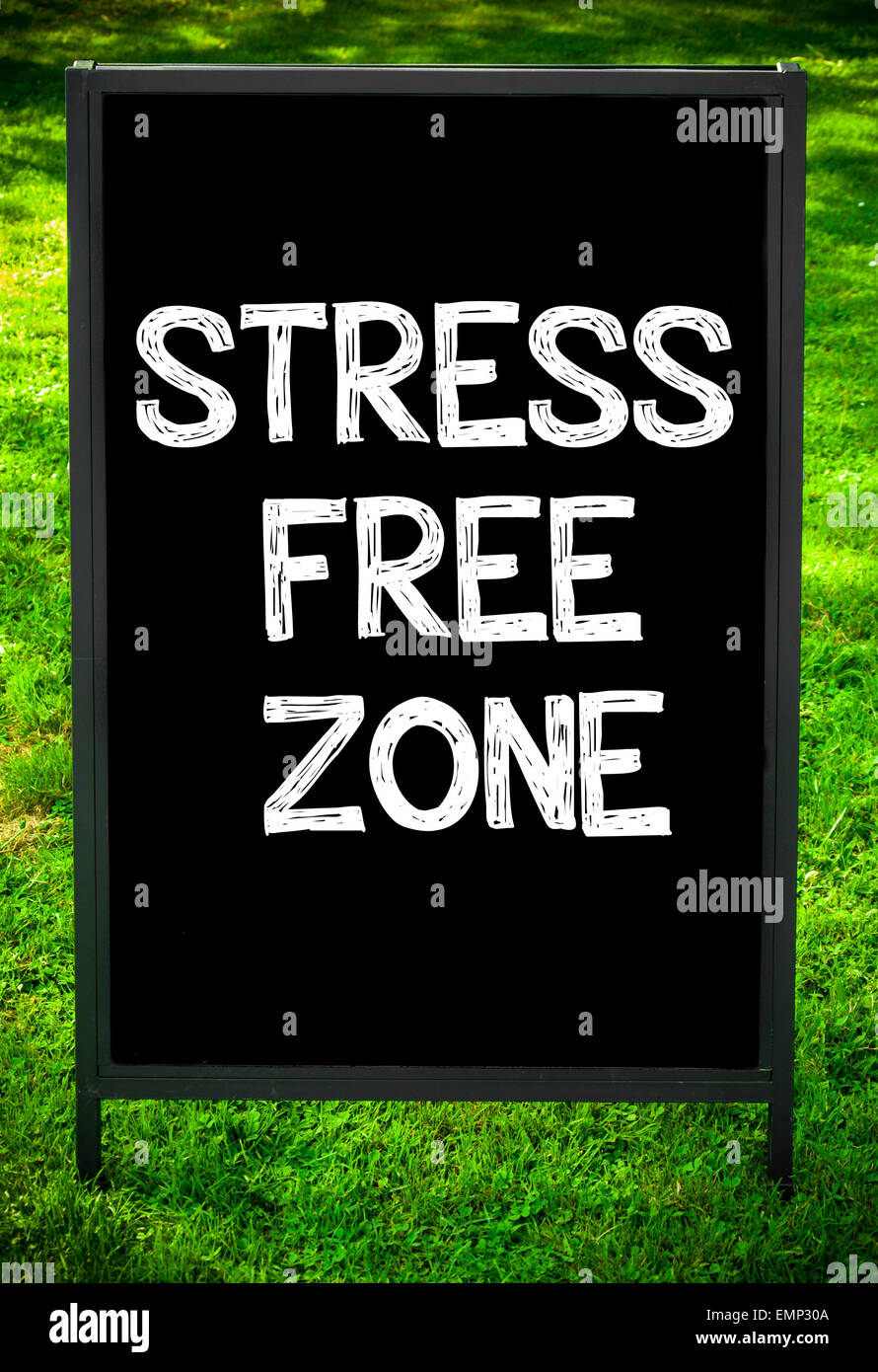 Zona SENZA STRESS messaggio sul marciapiede di blackboard segno contro erba verde dello sfondo. Copia dello spazio disponibile. Concetto di immagine Foto Stock