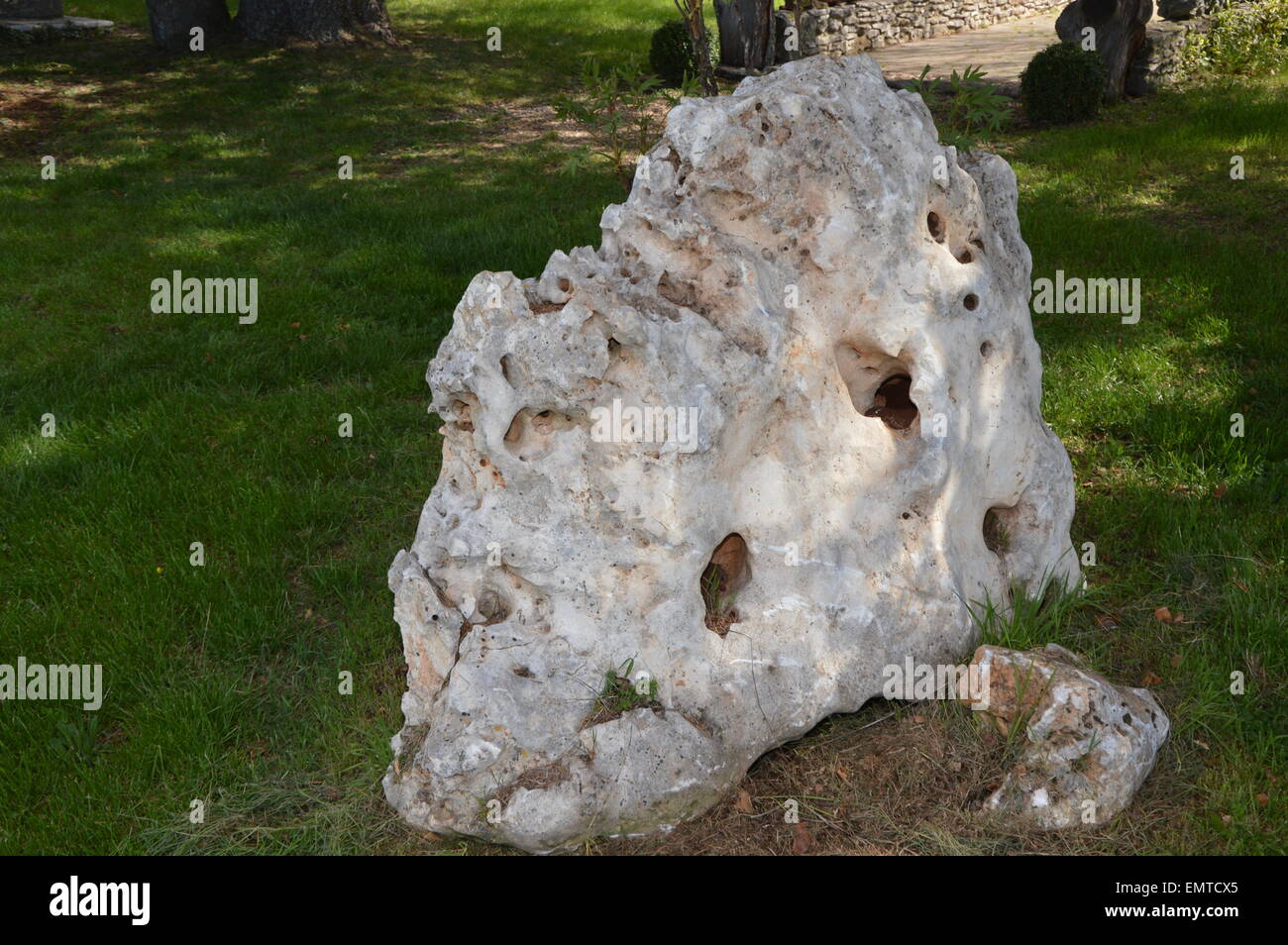 Una strana big rock in un giardino mediterraneo Foto Stock
