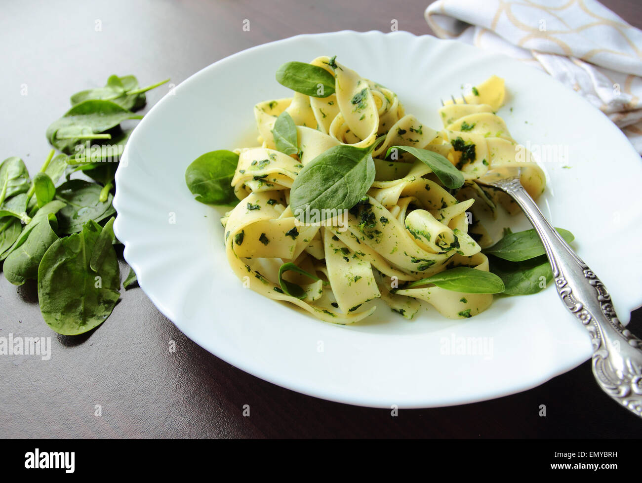 Pasta pappardelle con spinaci foglie sulla piastra bianca Foto Stock