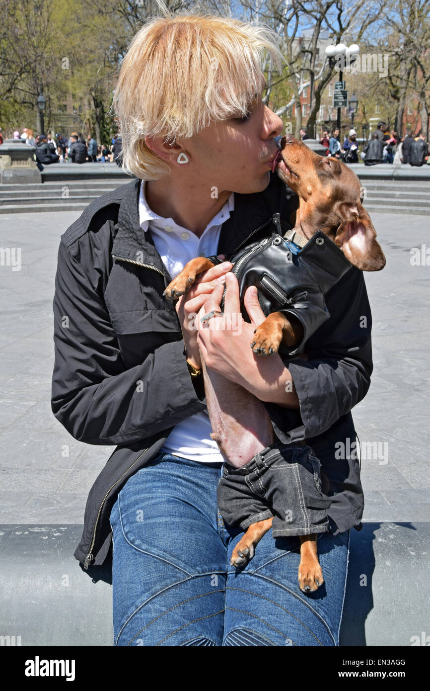 Ritratto di un uomo e il suo cane in costume in una giacca di pelle & jeans al giorno Bassotto a Washington Square Park, Greenwich Village, New York Foto Stock