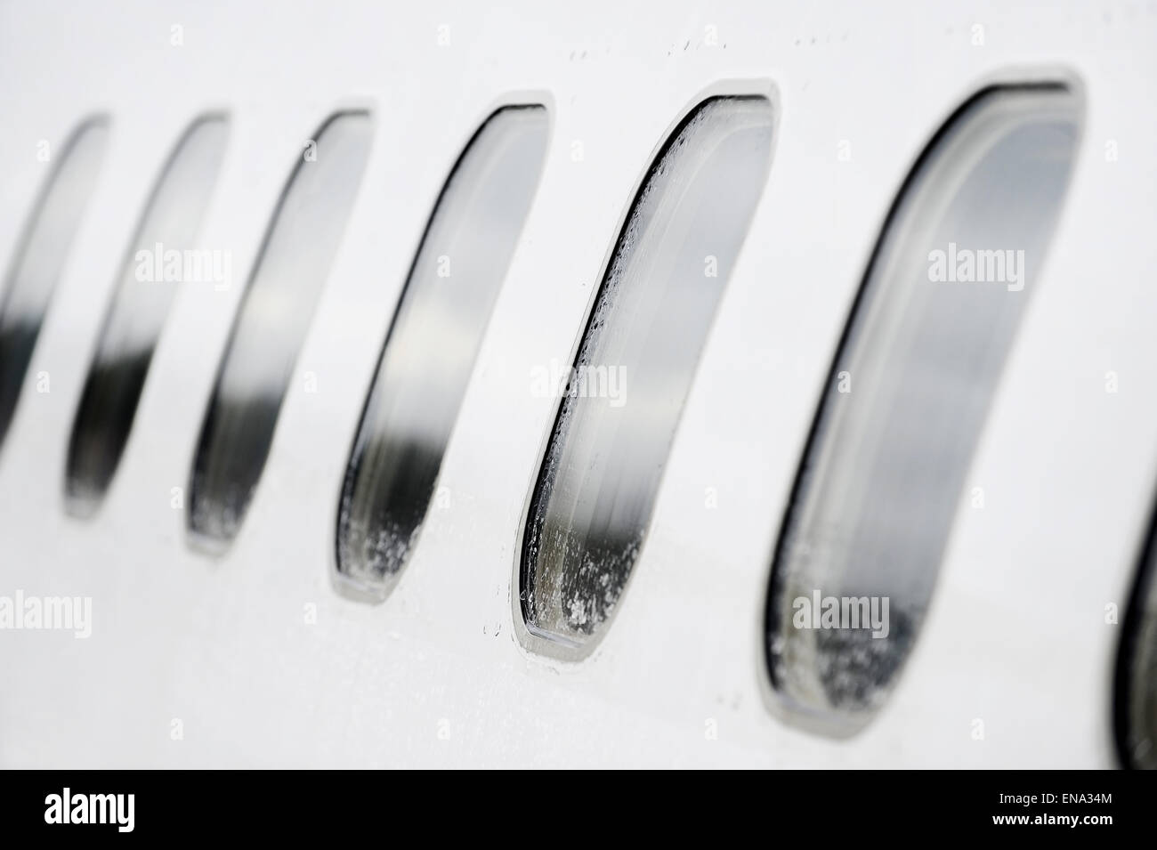 Aeroplano di windows in una fila con gocce di pioggia su di essi Foto Stock