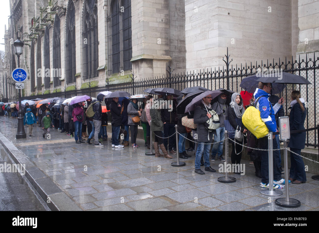 Coda di turisti sotto la pioggia per vedere la cattedrale di Notre Dame a Parigi Foto Stock