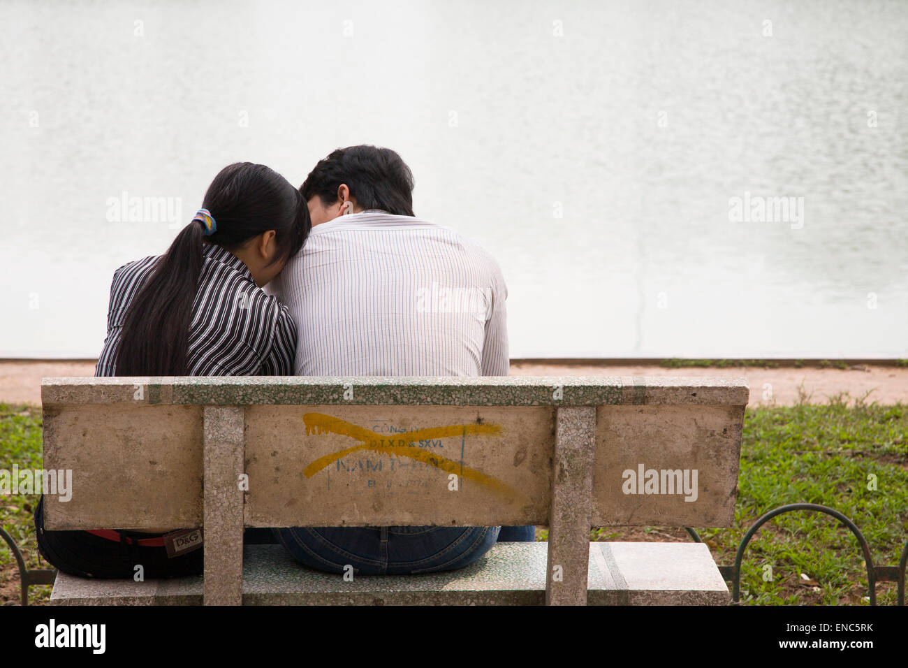 Una giovane coppia su un banco ad Hanoi, Vietnam Foto Stock