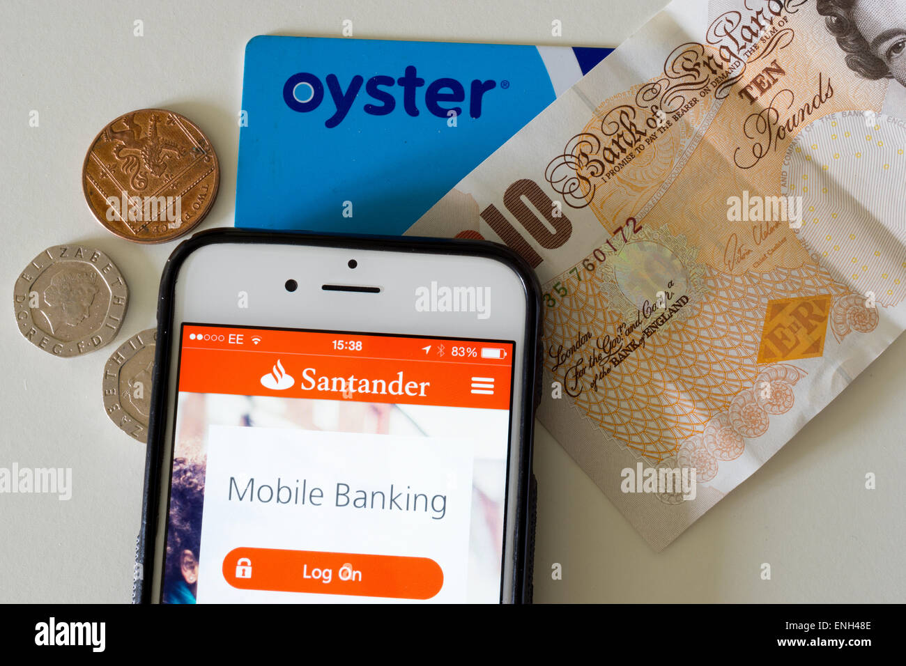 Moderni vari metodi di pagamento; contanti, un pagamento contactless card e mobile banking app visualizzata su un iPhone 6. Foto Stock