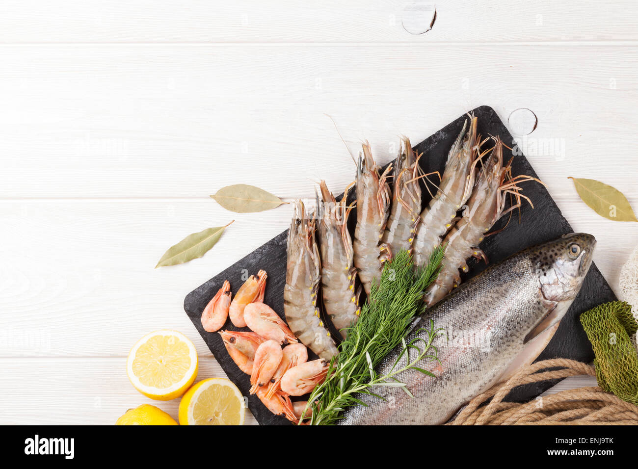 Crudo fresco il cibo del mare con spezie sul tavolo di legno dello sfondo. Vista da sopra con lo spazio di copia Foto Stock
