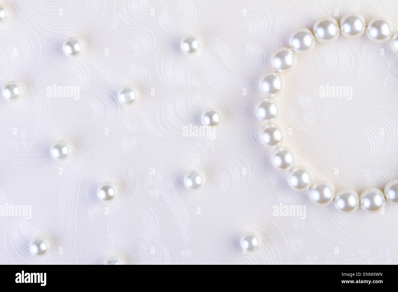 Perle bianche collana sul libro bianco sullo sfondo Foto Stock