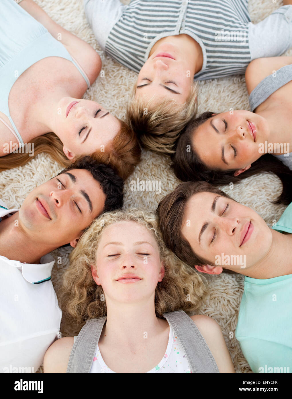 Gli amici con le loro teste insieme dormire a terra Foto Stock