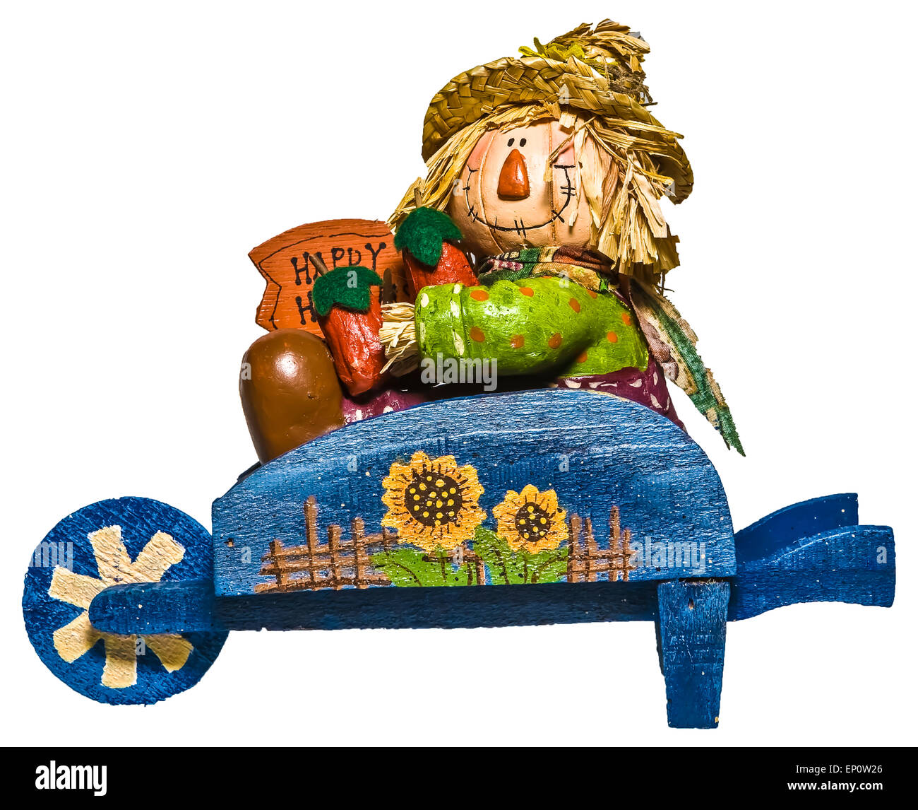 Il decor di caduta della paglia spaventapasseri farcite con peperoncino in legno blu carriola con fiori sul lato. Foto Stock