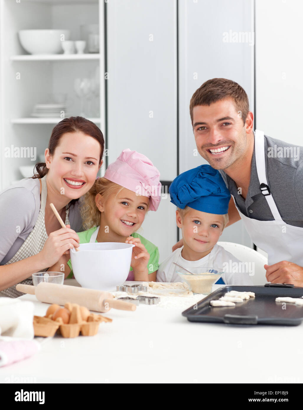 Genitori e childrnbaking insieme in cucina Foto Stock