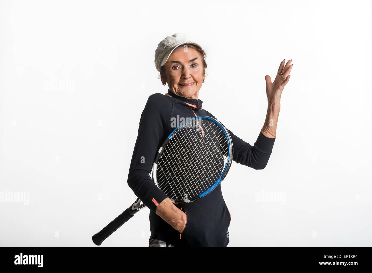 Ritratto in studio di 83 old guardando bene white senior donna su sfondo bianco con la racchetta da tennis Foto Stock