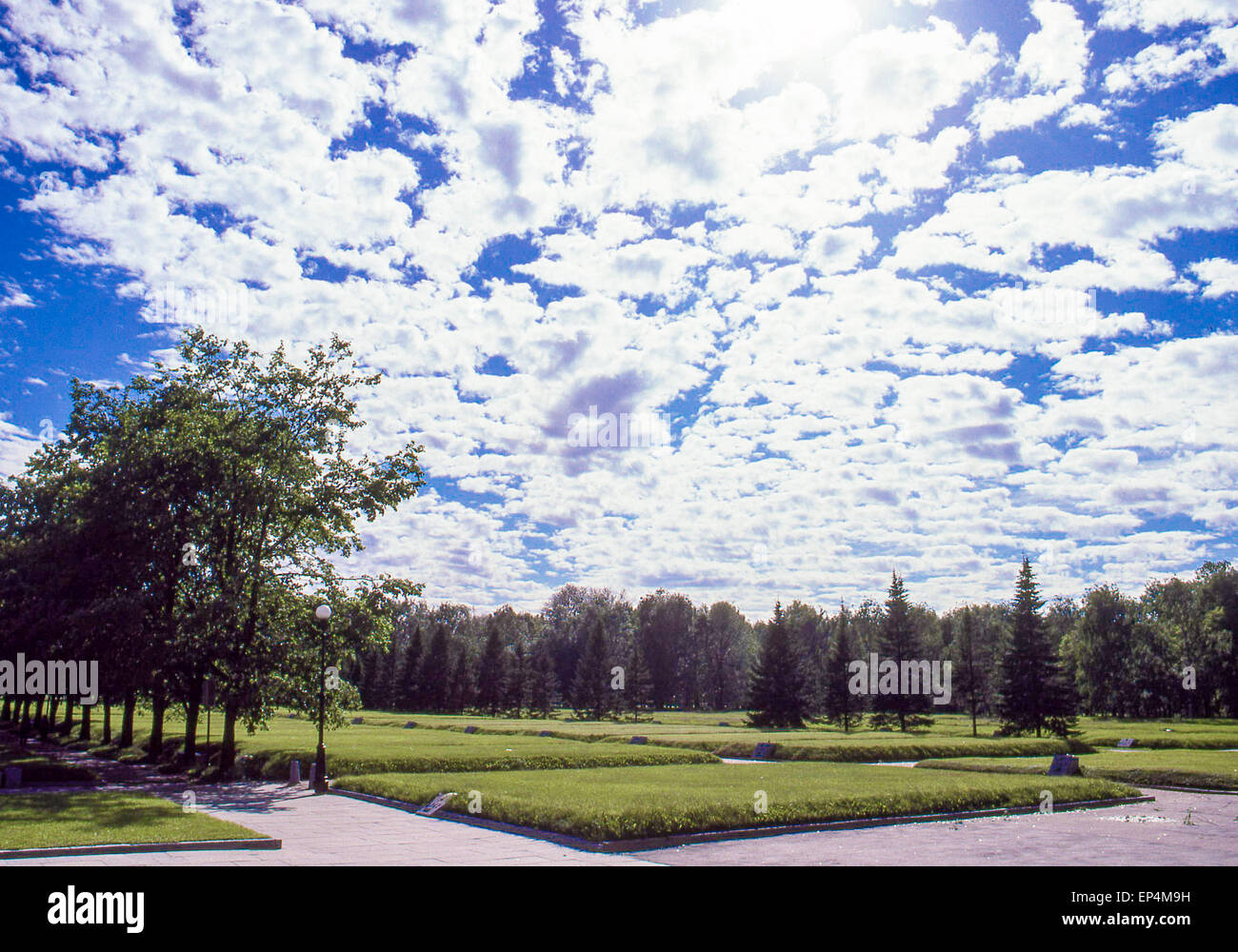 Giugno 25, 1989 - Leningrado (St. Petersburg, Russia - sotto una drammatica nube riempiva il cielo, 186 tombe di massa tratto all'orizzonte, su ogni tumulo sollevata una lastra di ottone con incisa una anno: 1941, 1942, 1943, all'Piskaryovskoye Memorial Cemetery di Leningrado (presente giorno San Pietroburgo) dove mezzo milione di persone, tra cui 420.000 civili e 50.000 soldati sono sepolti dopo perire durante l epica di 900 giorni di assedio da parte dei nazisti durante la seconda guerra mondiale. (Credito Immagine: © Arnold Drapkin/ZUMA filo) Foto Stock