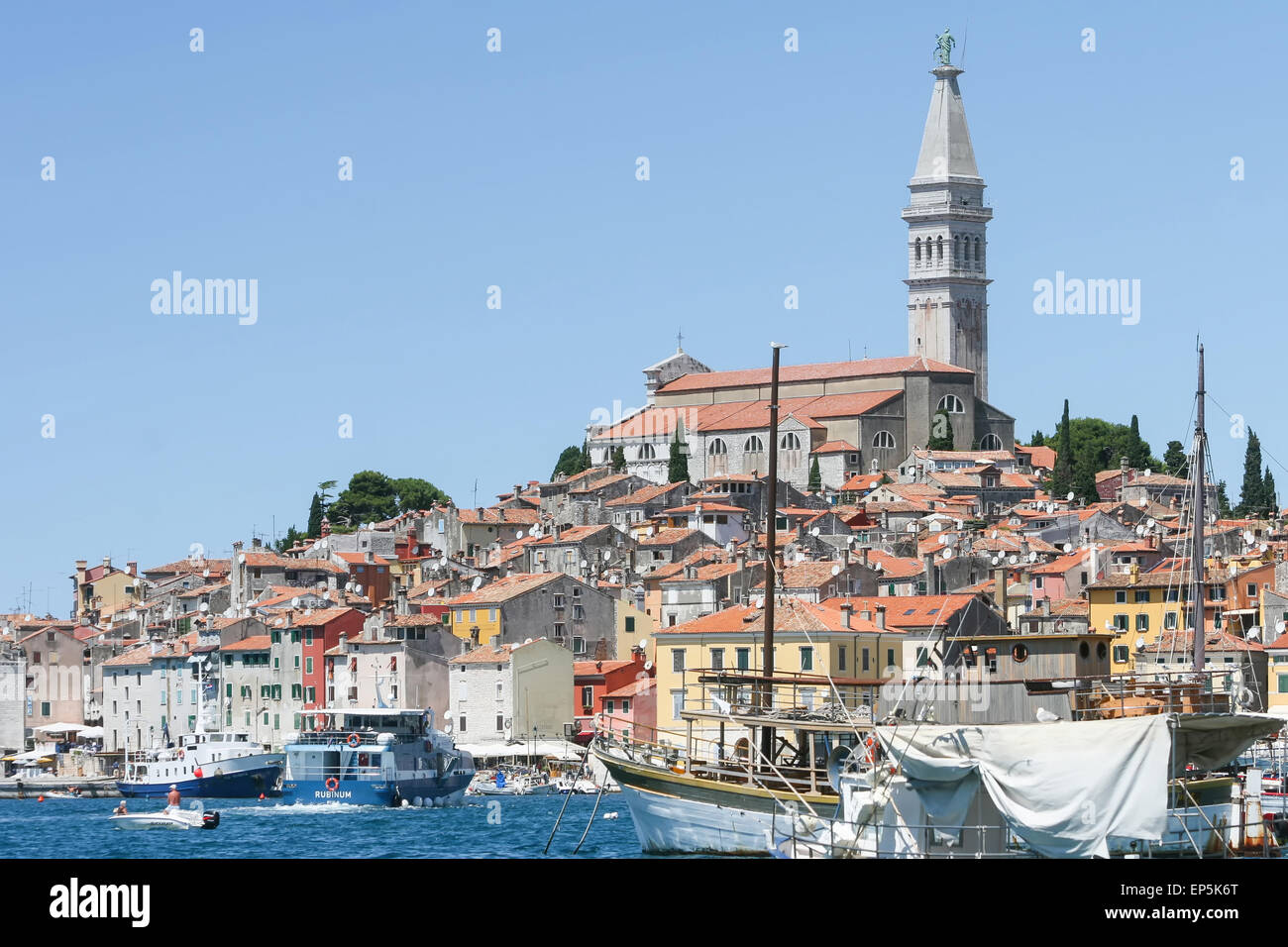 Barche e navi della marina e il nucleo storico della città con la Santa Eufemia chiesa in background di Rovigno Croazia. Foto Stock