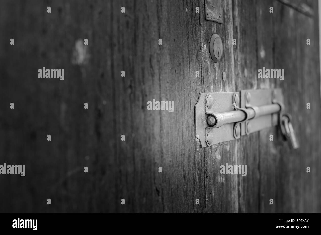 Il vecchio dispositivo di chiusura di una porta di legno di una stalla Foto Stock